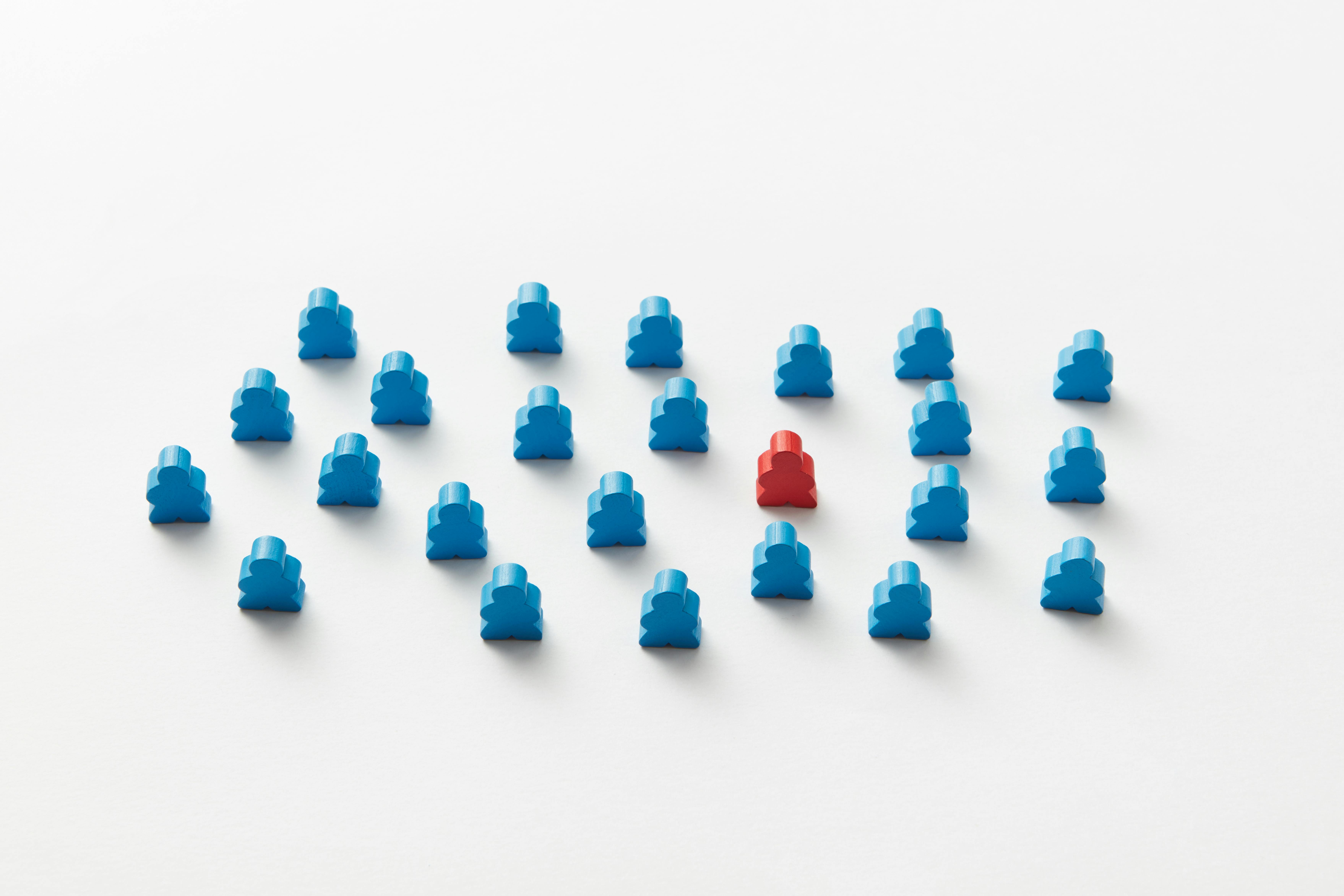 Colorful wooden meeples arranged on a game board